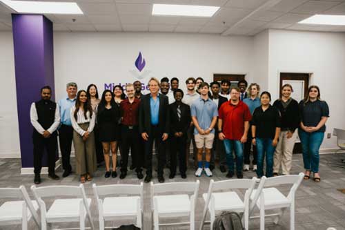 Matthew Stepka poses with students for a photo after his inagural Jennings Family Distinguished Lecture Series.